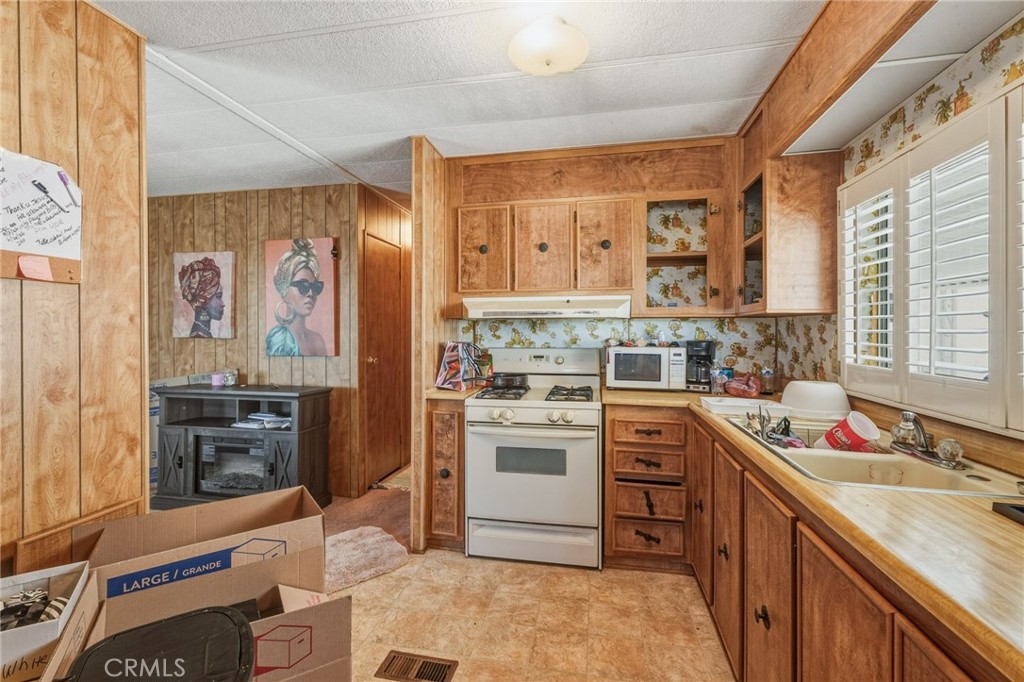 20683 Waalew Road, Unit B201 Apple Valley, CA 92307 - Photo 14 of 32 a kitchen with stainless steel appliances granite countertop a stove and a sink
