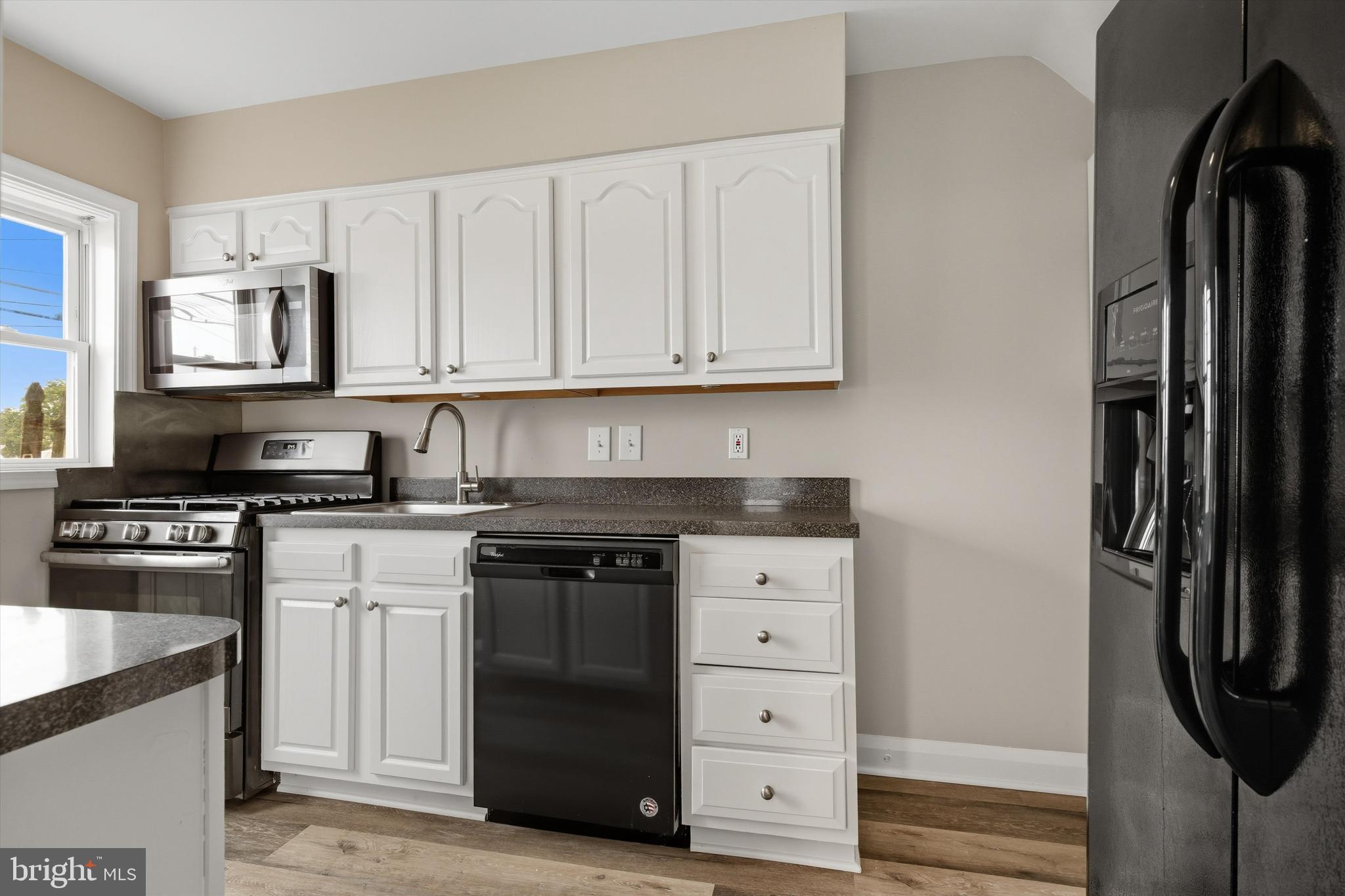 7948 Kavanagh Road Baltimore, MD 21222 - Photo 8 of 26 a kitchen with stainless steel appliances granite countertop a refrigerator and a stove top oven