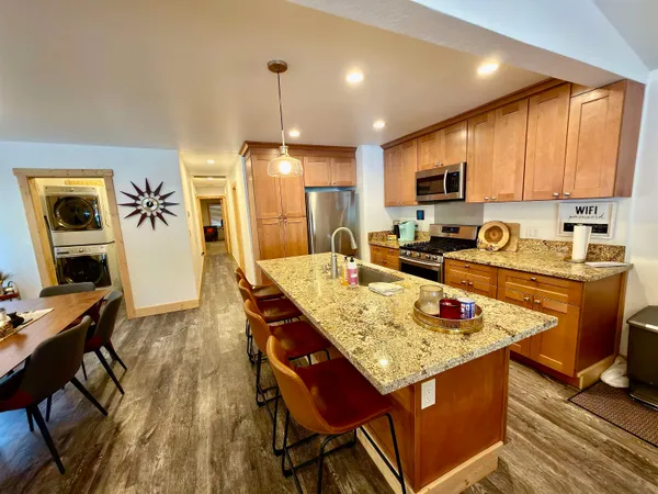 a kitchen with stainless steel appliances granite countertop a sink stove and refrigerator
