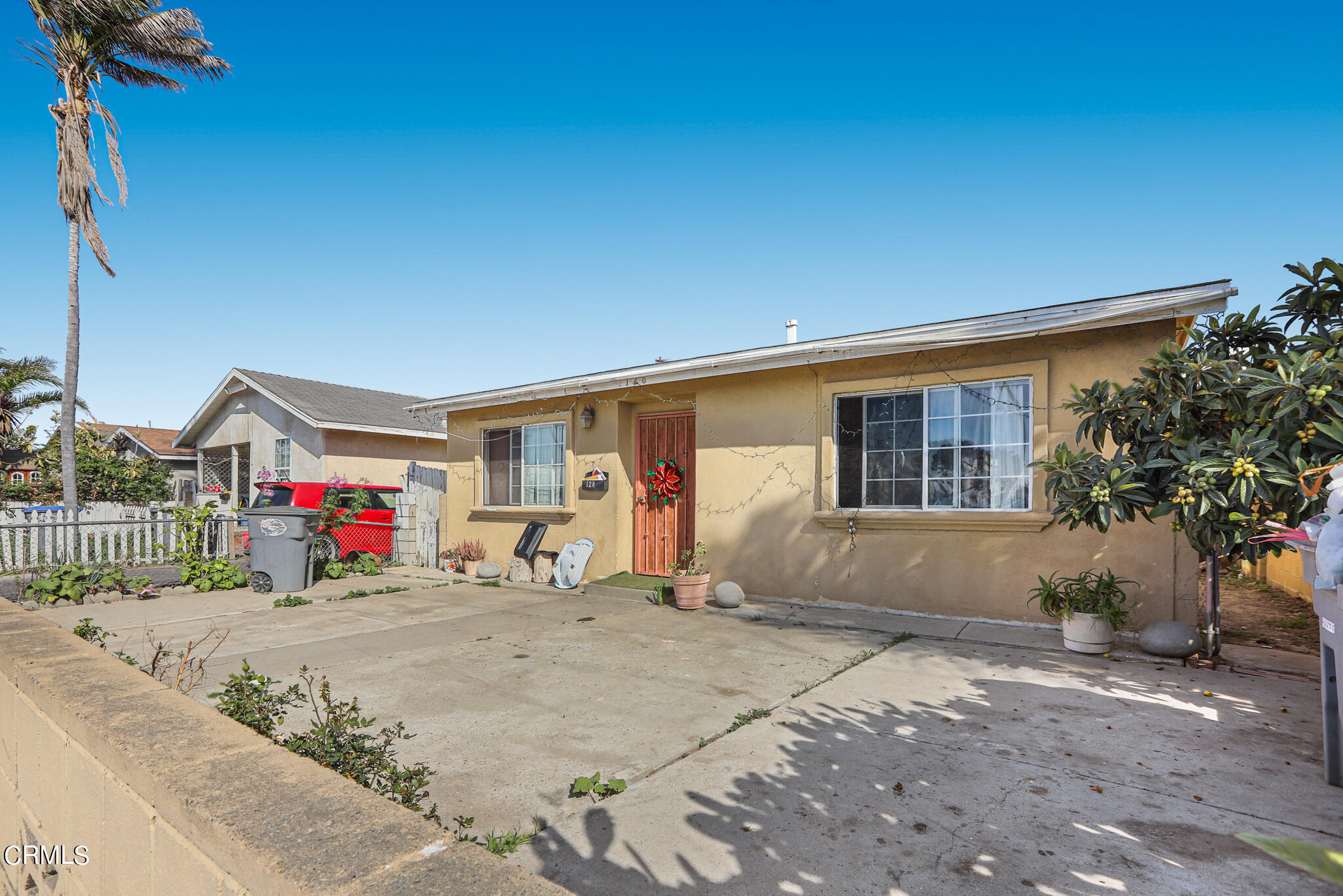 128 North Harrison Avenue Oxnard, CA 93030 - Photo 2 of 10 a view of a house with a small yard and potted plants