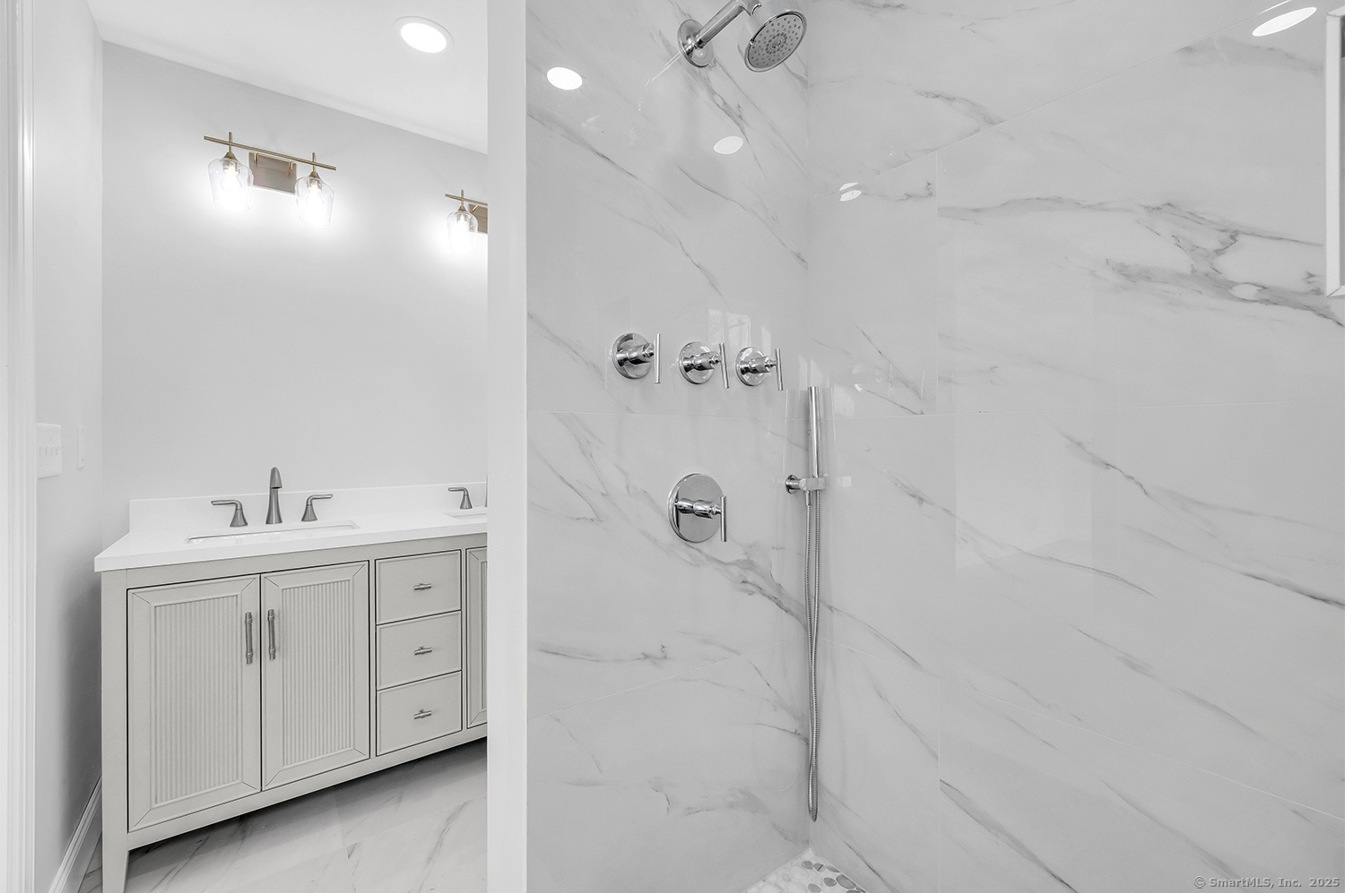 197 Vesper Street Fairfield, CT 06825 - Photo 11 of 21 a bathroom with a double vanity sink a toilet and shower