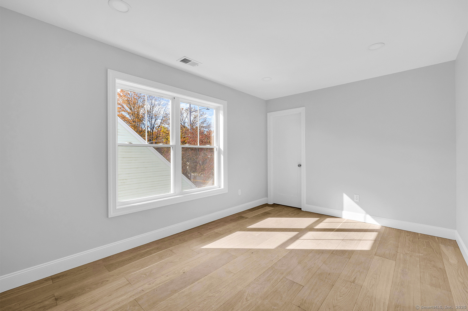 197 Vesper Street Fairfield, CT 06825 - Photo 13 of 21 an empty room with wooden floor and windows