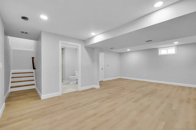 a view of an empty room with wooden floor