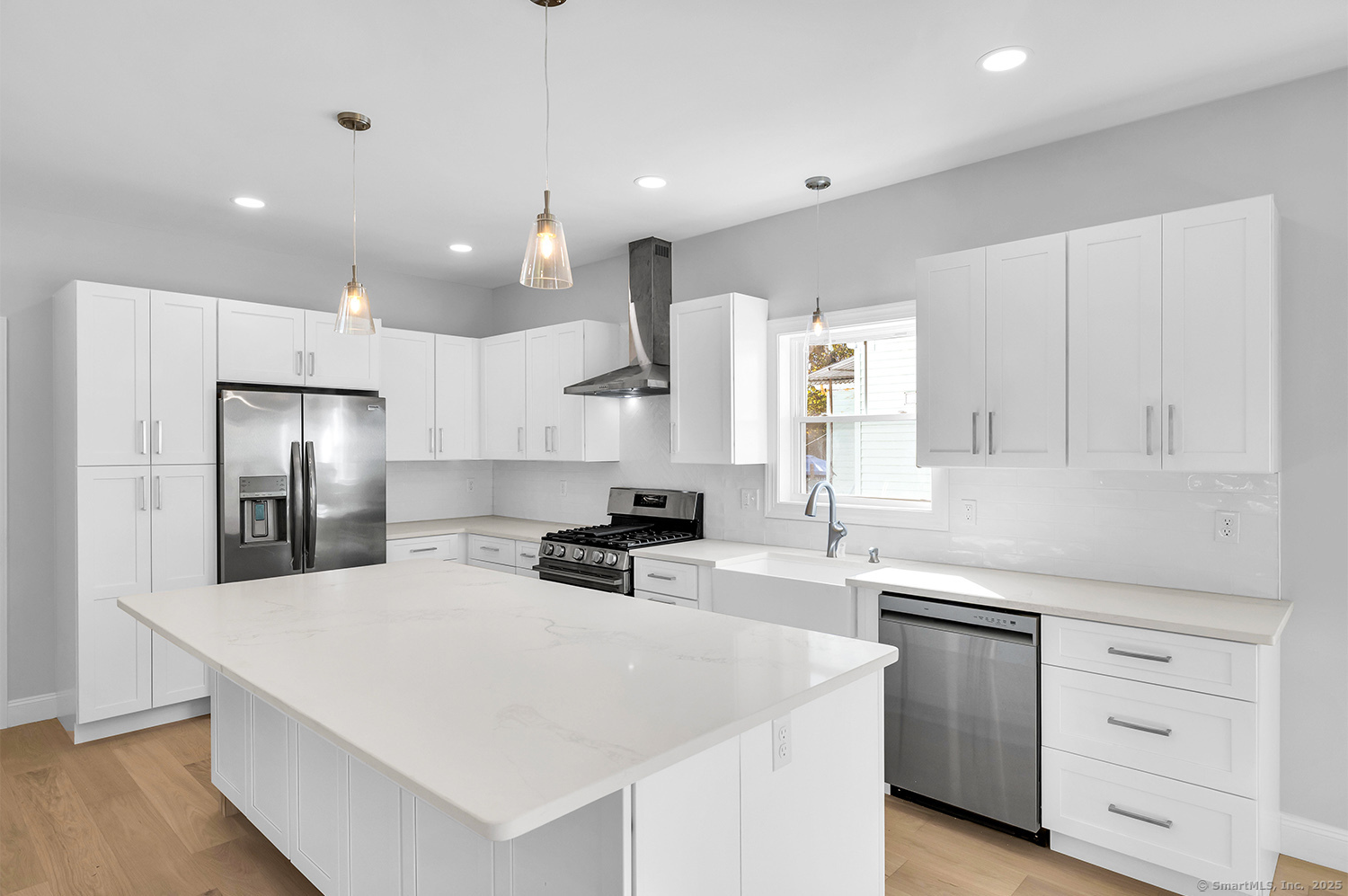 197 Vesper Street Fairfield, CT 06825 - Photo 6 of 21 a kitchen with a sink a stove a refrigerator and white cabinets