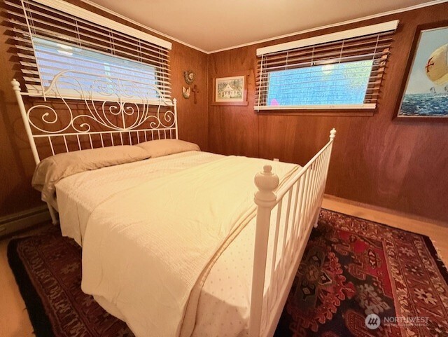 27728 Manzanita Beach Road Southwest Vashon, WA 98070 - Photo 11 of 17 a bedroom with a bed and wooden floor