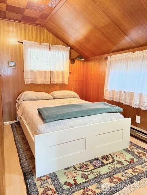 27728 Manzanita Beach Road Southwest Vashon, WA 98070 - Photo 12 of 17 a bedroom with a bed and a dresser