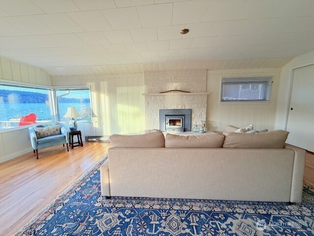 27728 Manzanita Beach Road Southwest Vashon, WA 98070 - Photo 7 of 17 a living room with furniture and a fireplace
