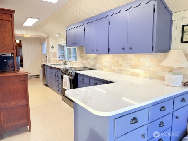 27728 Manzanita Beach Road Southwest Vashon, WA 98070 - Photo 10 of 17 a kitchen with a stove a sink and a refrigerator