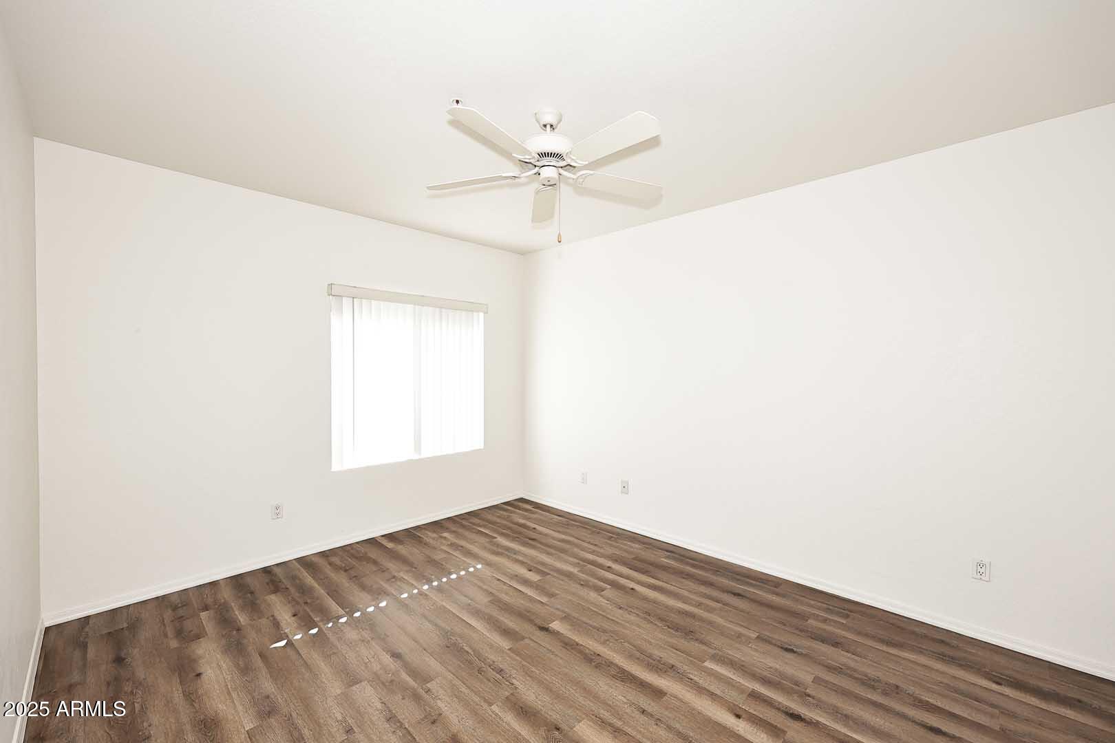 295 North Rural Road, Unit 164 Chandler, AZ 85226 - Photo 13 of 24 a view of a room with wooden floor and a ceiling fan