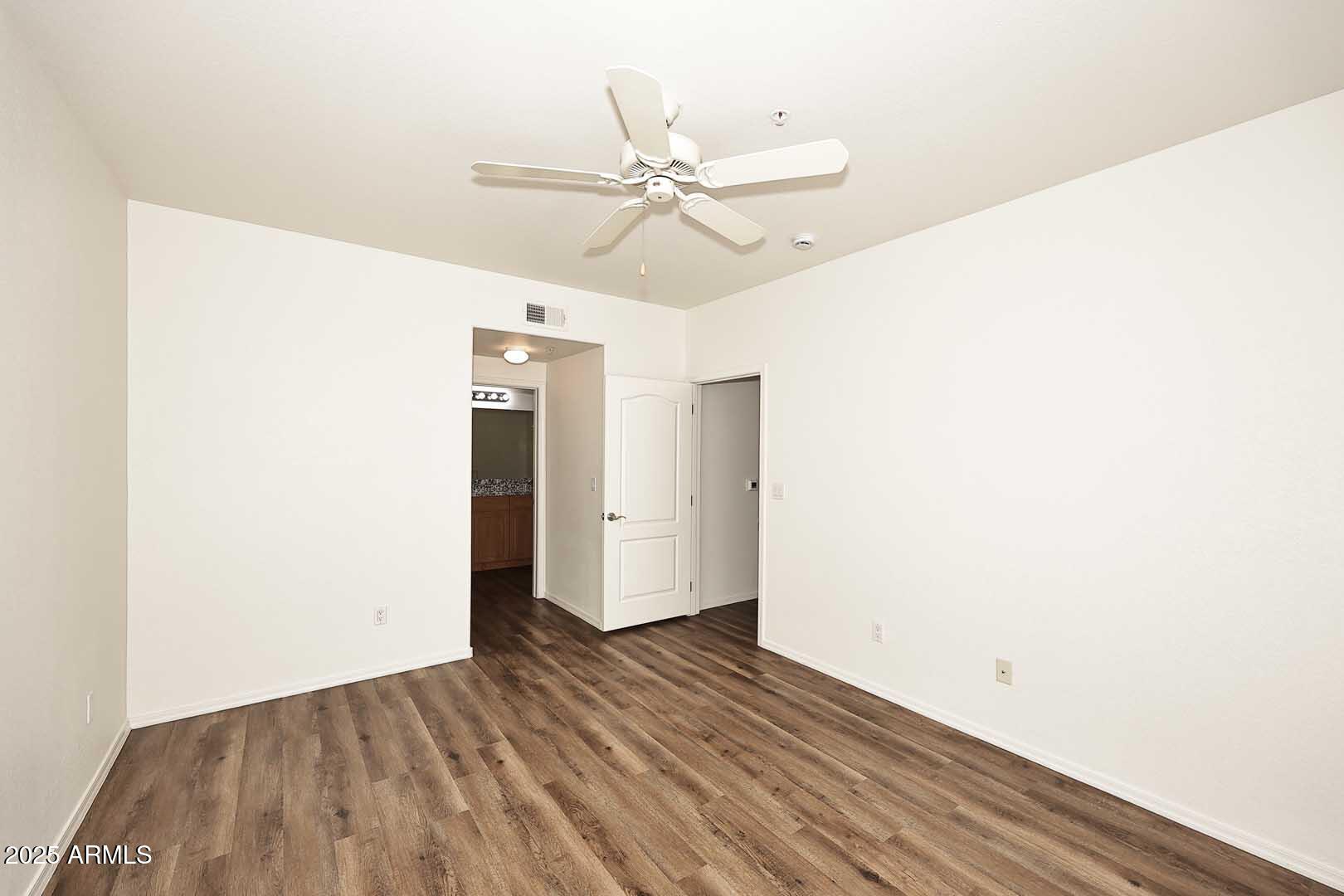 295 North Rural Road, Unit 164 Chandler, AZ 85226 - Photo 15 of 24 a view of a room with wooden floor and ceiling fan