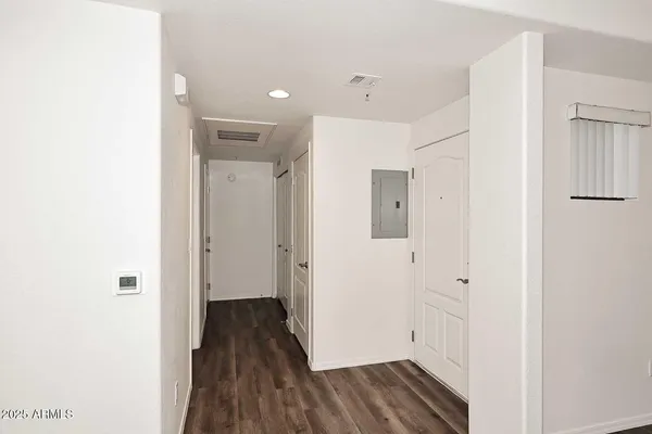 a view of a hallway with wooden floor