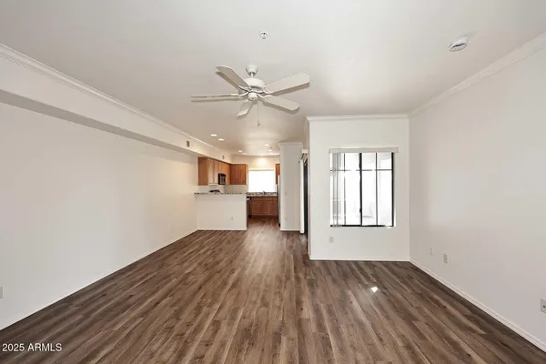 a view of kitchen and hall with wooden floor
