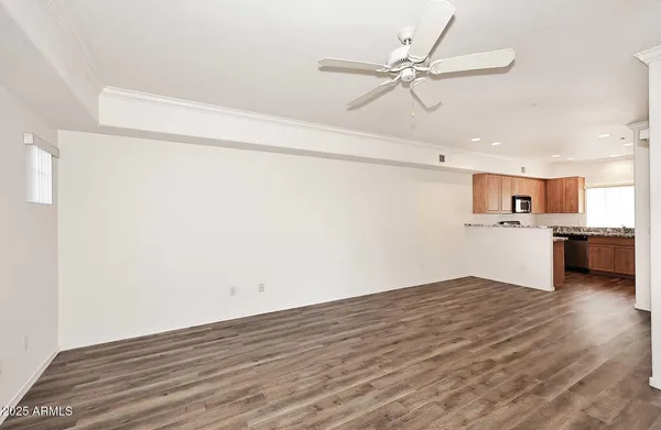 a view of a kitchen with a sink dishwasher a refrigerator with wooden floor