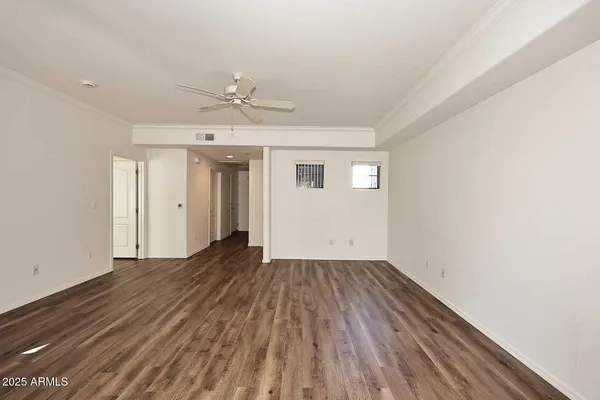 wooden floor in an empty room with a window