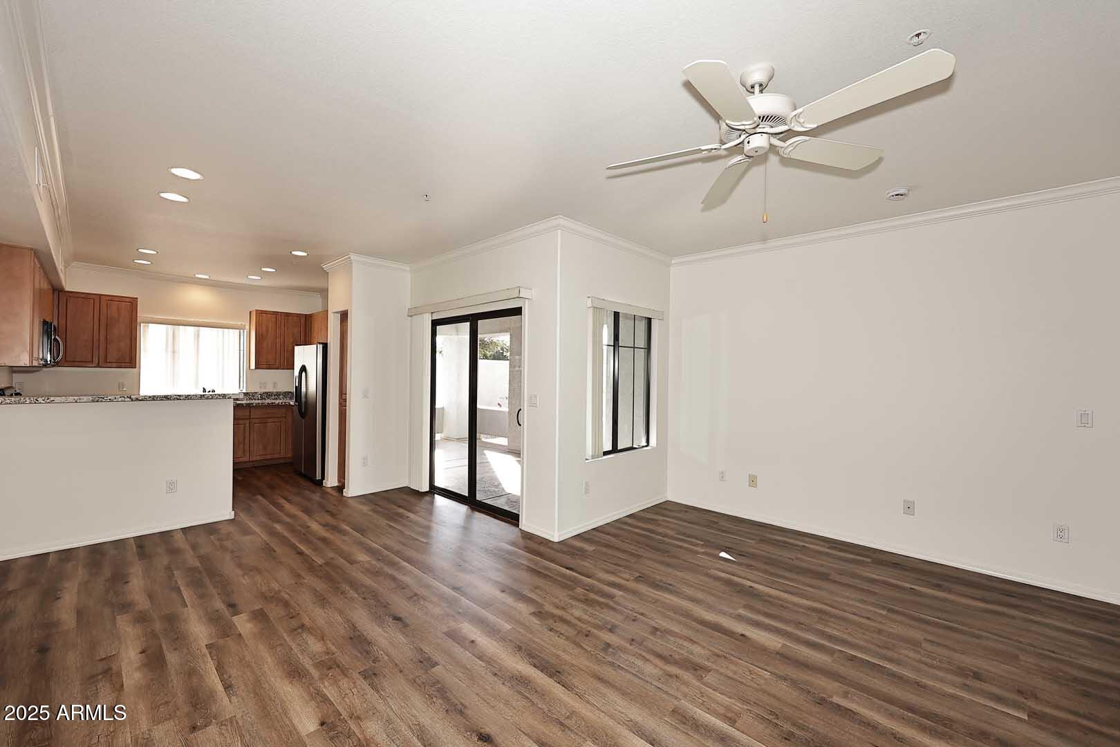 295 North Rural Road, Unit 164 Chandler, AZ 85226 - Photo 7 of 24 a view of an empty room with wooden floor and a window
