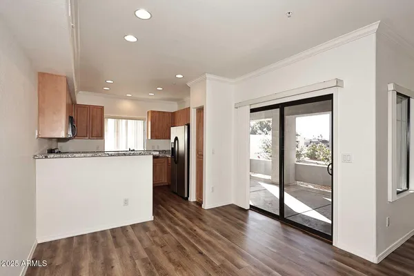 a view of a kitchen with wooden floor and a window