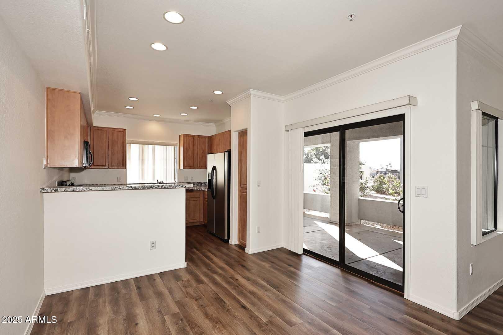 295 North Rural Road, Unit 164 Chandler, AZ 85226 - Photo 8 of 24 a view of a kitchen with wooden floor and a window