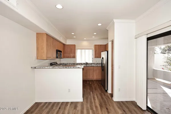 a kitchen with stainless steel appliances a refrigerator and a stove top oven