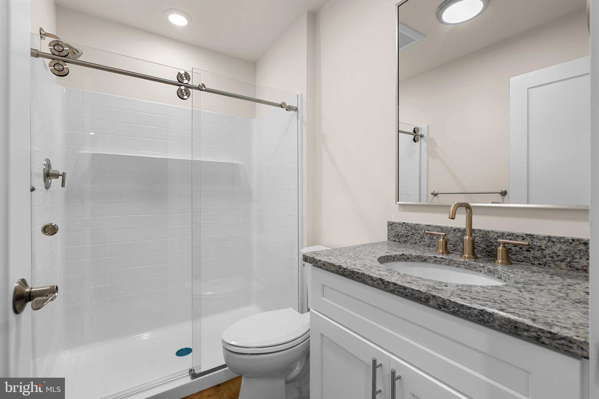 30 West Broad Street Souderton, PA 18964 - Photo 11 of 41 a bathroom with a granite countertop sink toilet and shower