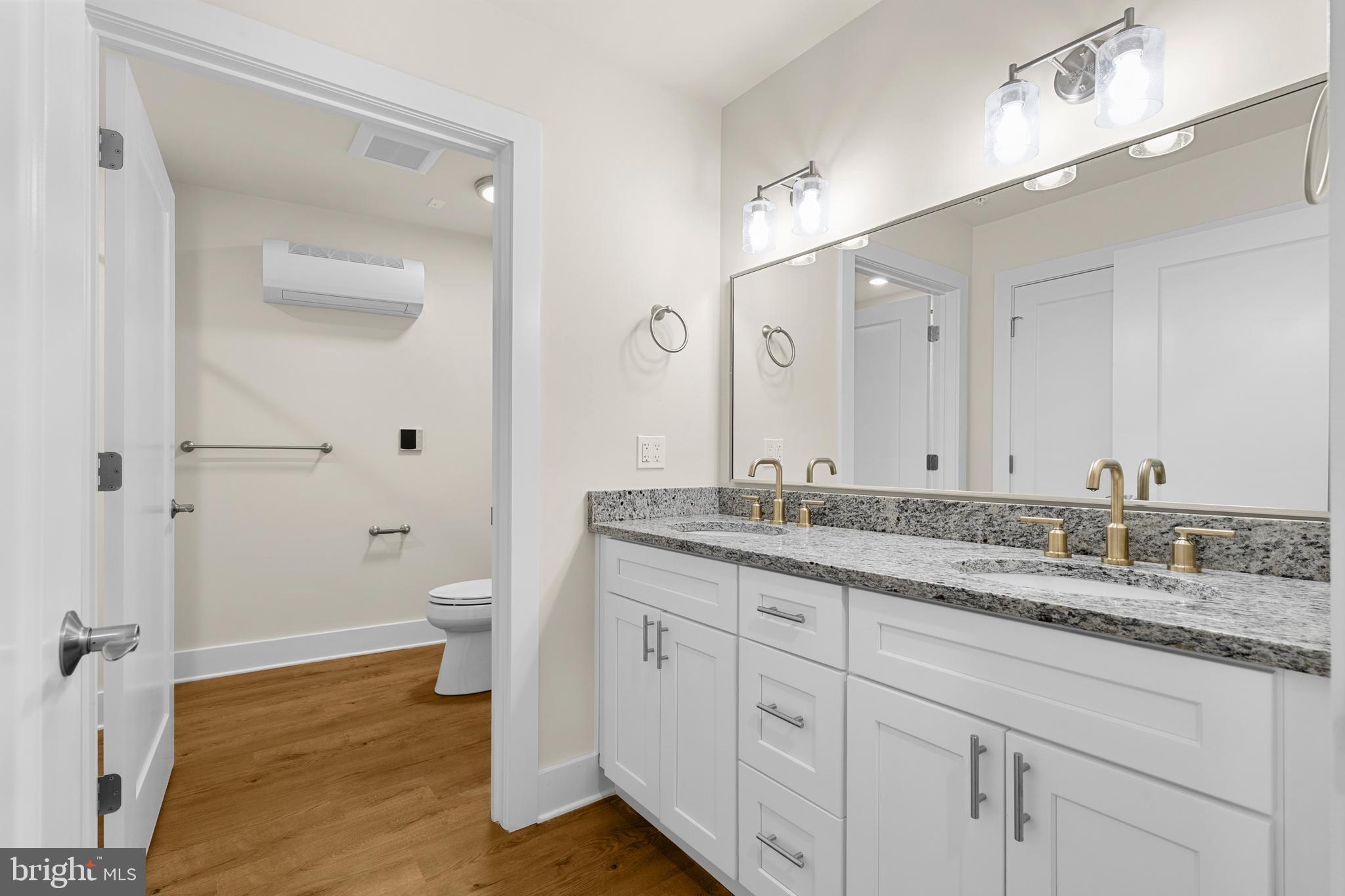 30 West Broad Street Souderton, PA 18964 - Photo 15 of 41 a bathroom with a granite countertop sink a toilet and a mirror