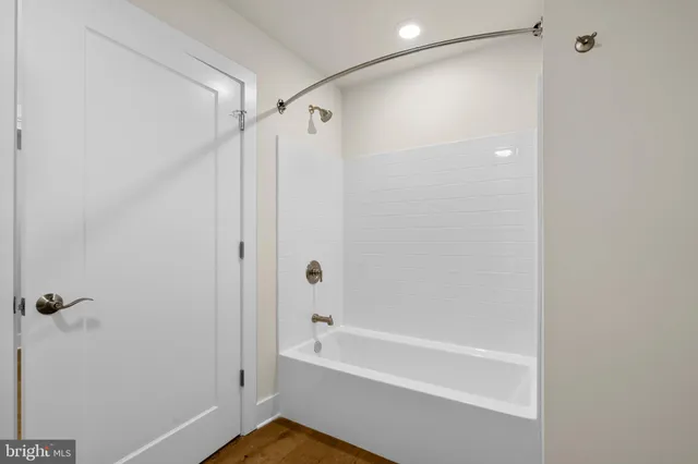 a white toilet sitting next to a shower