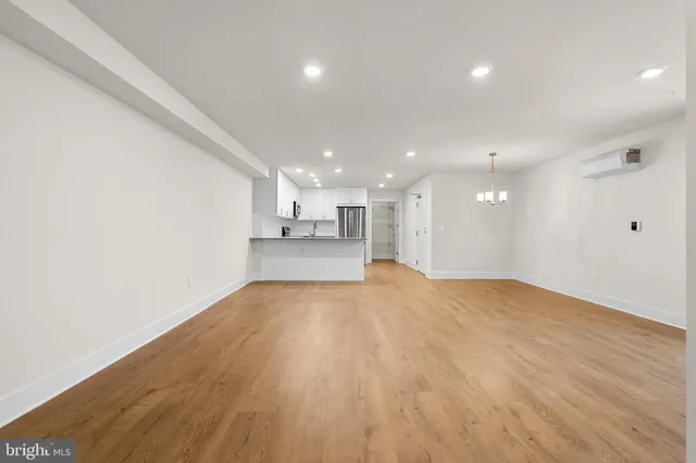 a view of a kitchen with a sink and a refrigerator