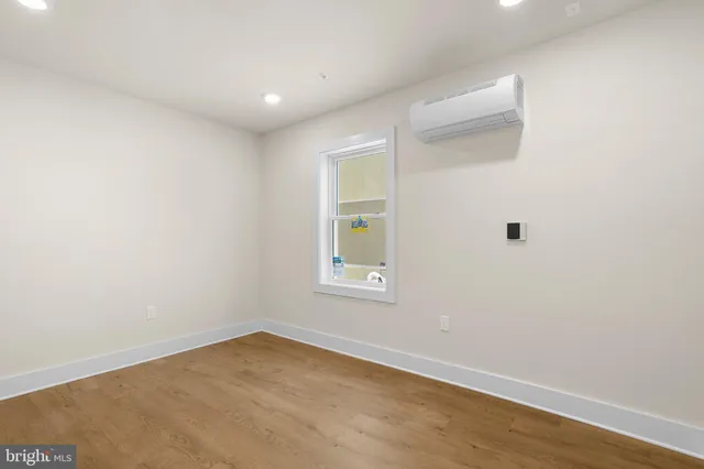an empty room with windows and closet