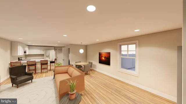 a living room with stainless steel appliances furniture a flat screen tv and kitchen view