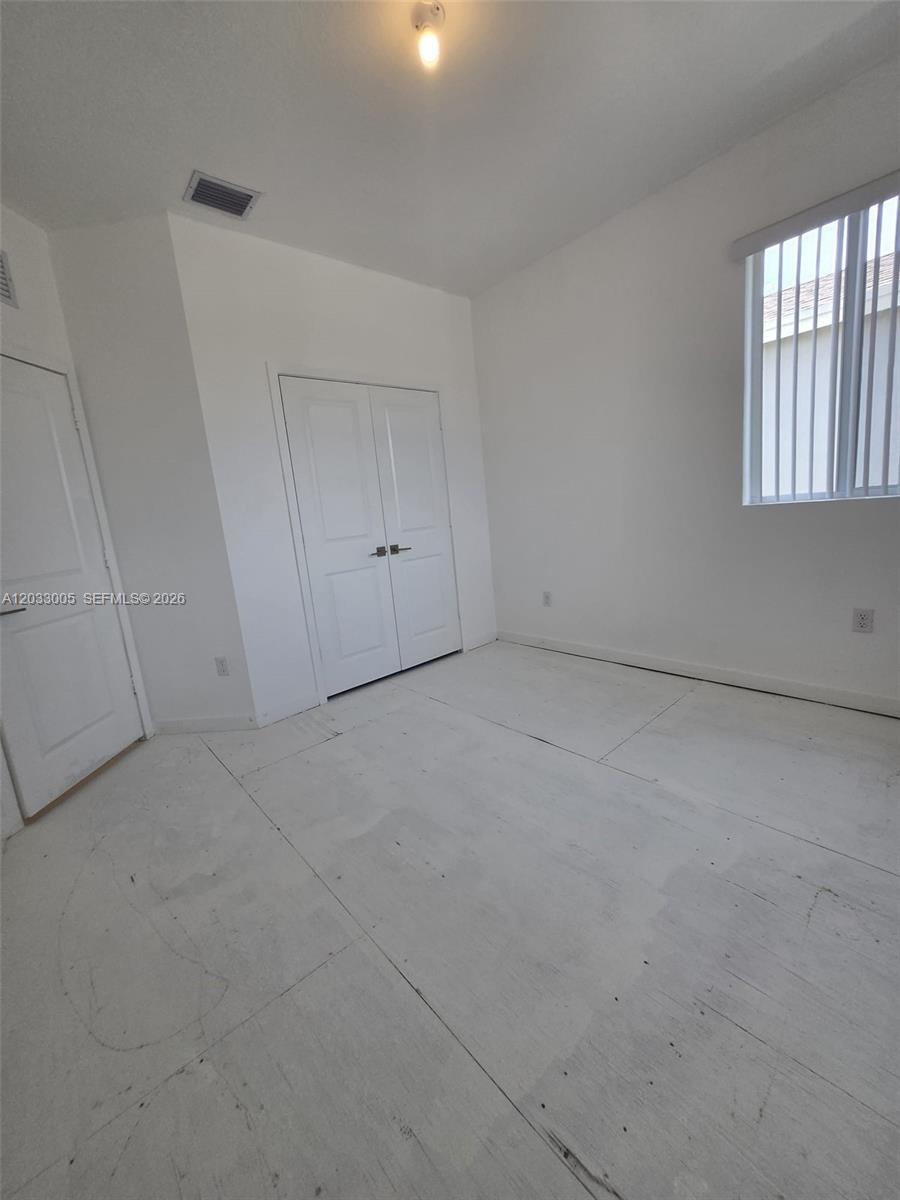 862 Southeast 17 Street, Unit 862 Homestead, FL 33034 - Photo 7 of 39 a view of an empty room and a window