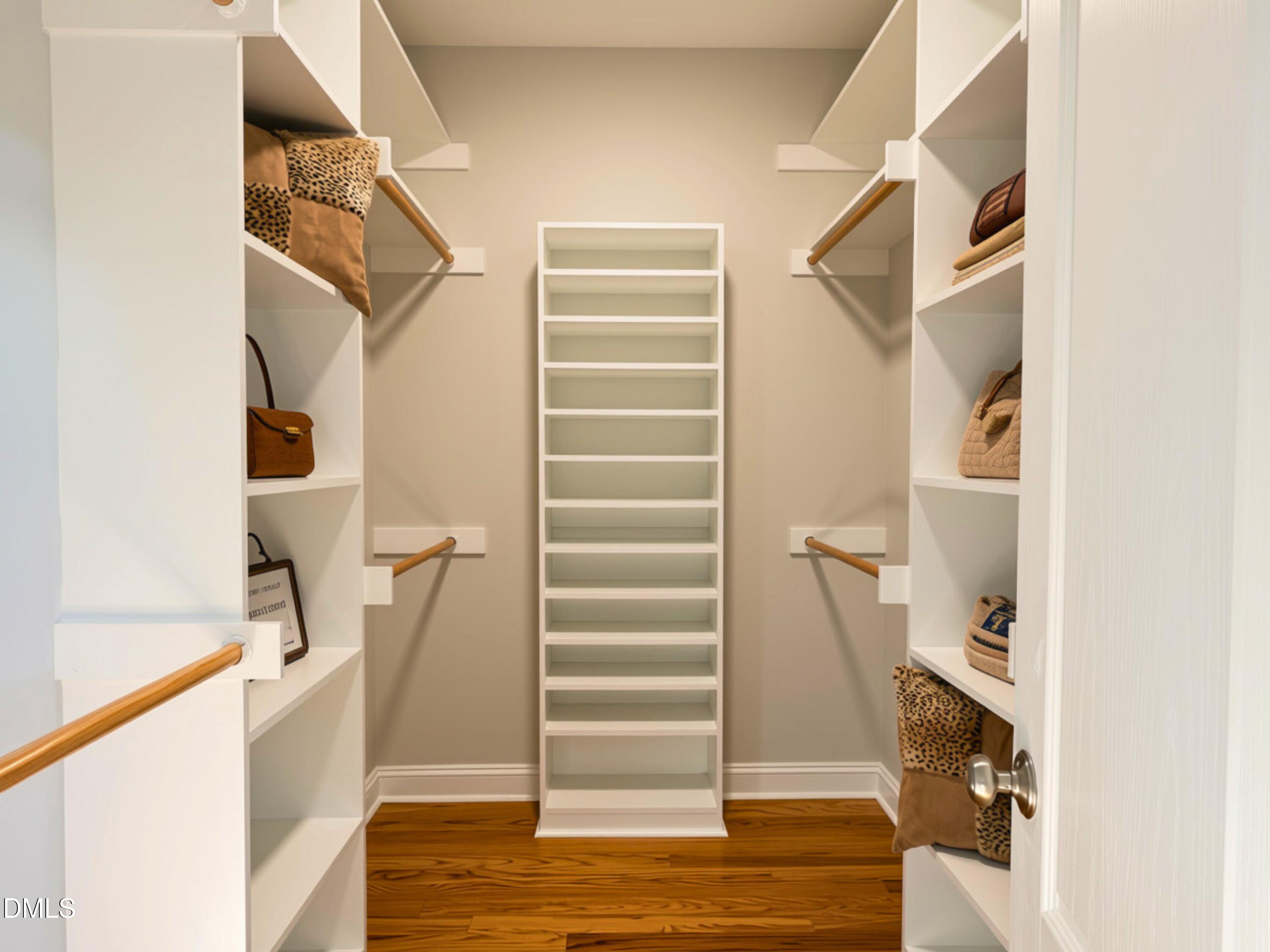 3100 Donlin Drive Wake Forest, NC 27587 - Photo 26 of 67 Built-in shelving, hanging rods, central shoe rack, and wood-finish flooring