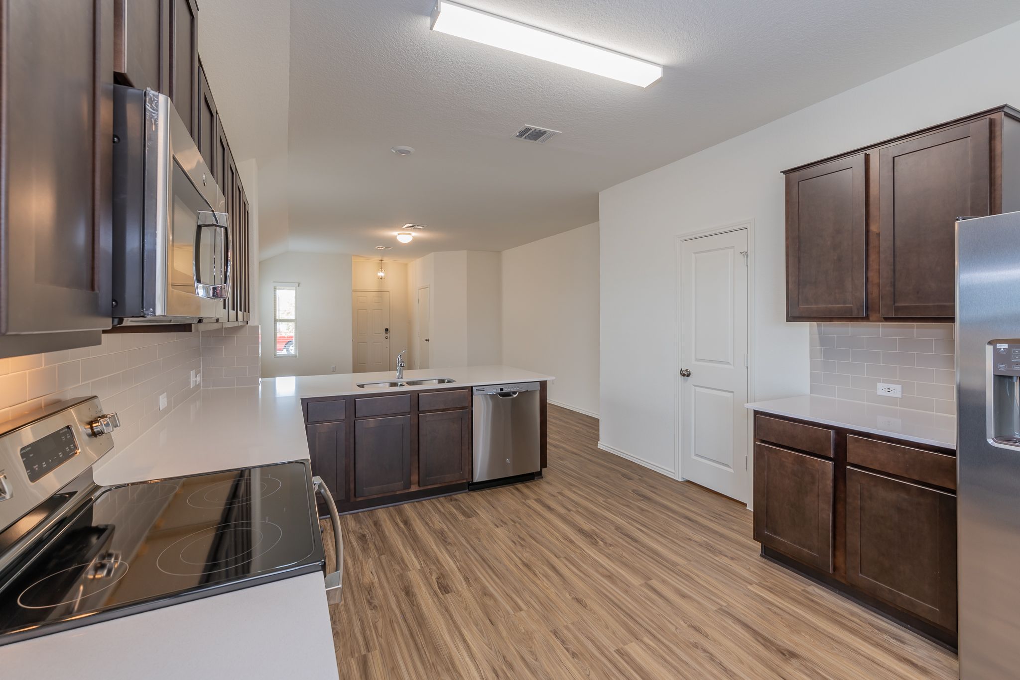 509 Greatest Gift Way Jarrell, TX 76537 - Photo 12 of 28 a room with wooden floor and staircase