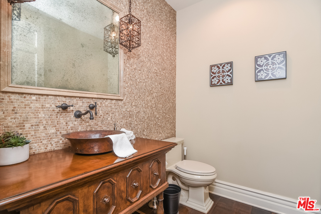 3901 Longridge Avenue Sherman Oaks, CA 91423 - Photo 19 of 51 a bathroom with a sink a toilet and a mirror