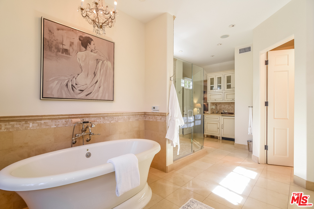 3901 Longridge Avenue Sherman Oaks, CA 91423 - Photo 25 of 51 a bathroom with a tub a sink and a shower
