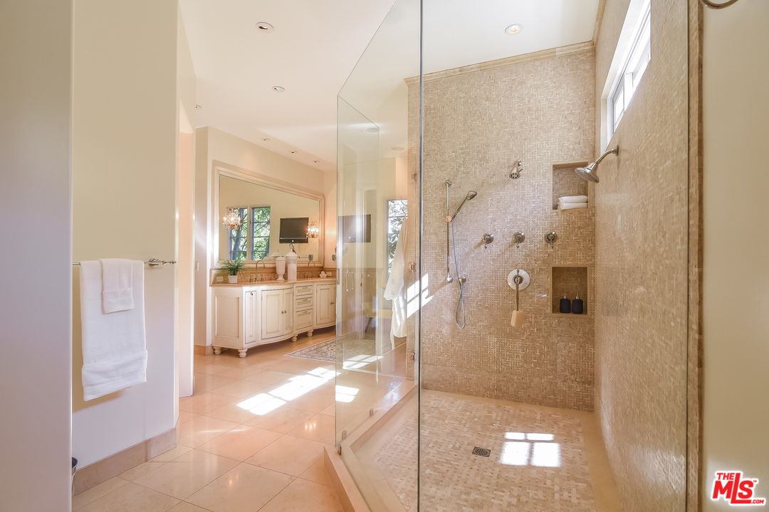 3901 Longridge Avenue Sherman Oaks, CA 91423 - Photo 26 of 51 a bathroom with a glass shower door and a sink