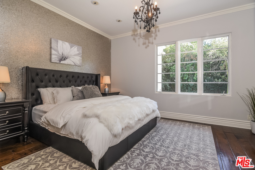 3901 Longridge Avenue Sherman Oaks, CA 91423 - Photo 27 of 51 a bed sitting in a bedroom next to a window