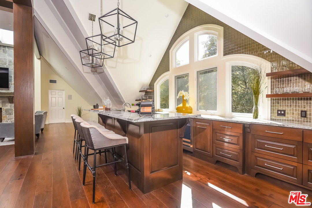 3901 Longridge Avenue Sherman Oaks, CA 91423 - Photo 40 of 51 a kitchen with a sink dining table and chairs