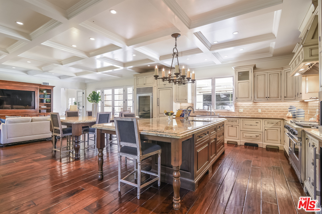 3901 Longridge Avenue Sherman Oaks, CA 91423 - Photo 7 of 51 a kitchen with lots of counter top space and wooden floor