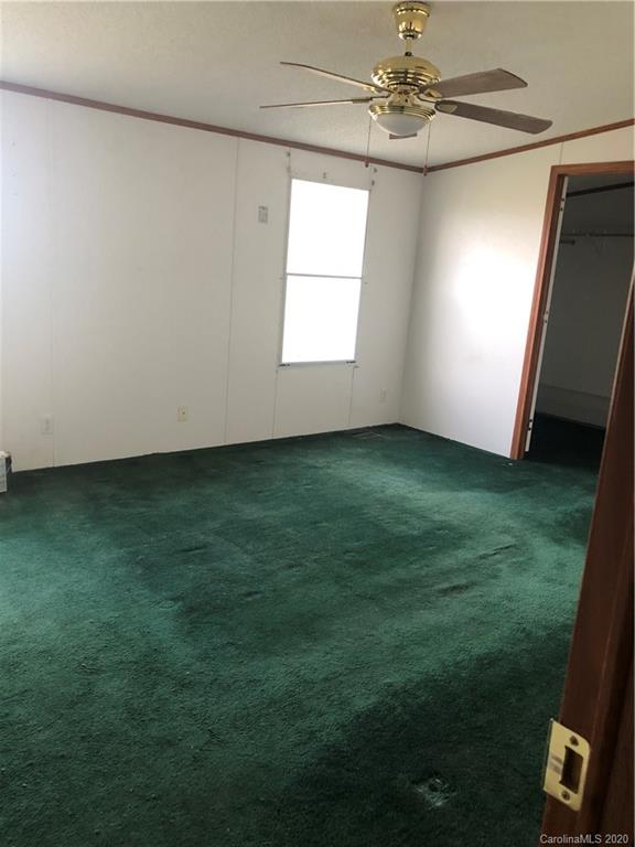 140 Rithmetic Road Salisbury, NC 28147 - Photo 8 of 18 a view of an empty room with a fireplace and a window