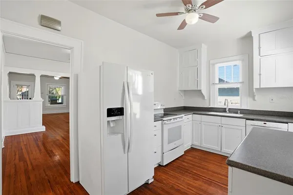 a kitchen with stainless steel appliances a refrigerator and a stove top oven