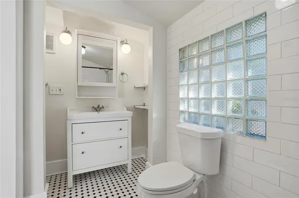 a bathroom with a toilet a sink and a shower