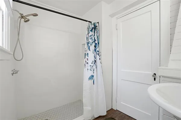 a bathroom with a shower curtain and a shower