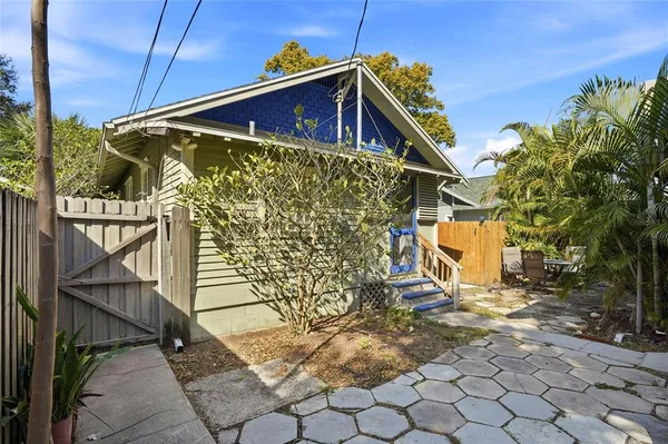 a front view of a house with plants