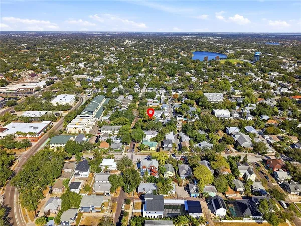 an aerial view of residential houses with city view