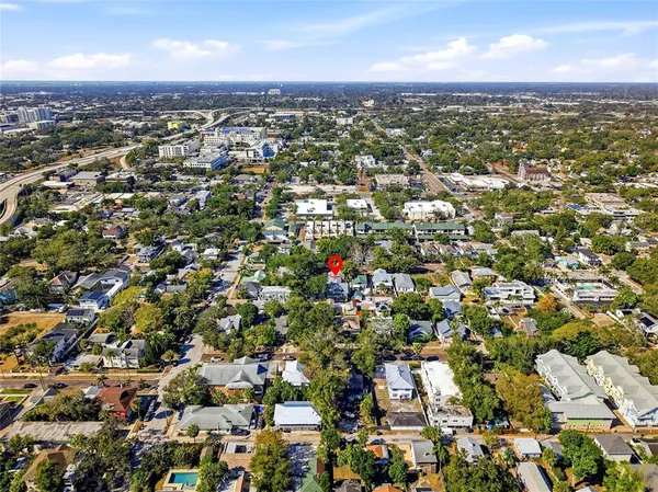 an aerial view of residential houses with city view