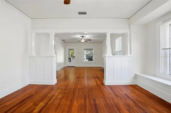 a view of livingroom with hardwood floor and a kitchen