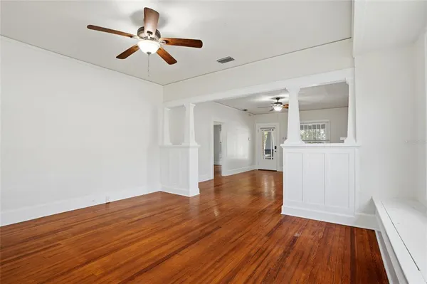 wooden floor in an empty room with a window