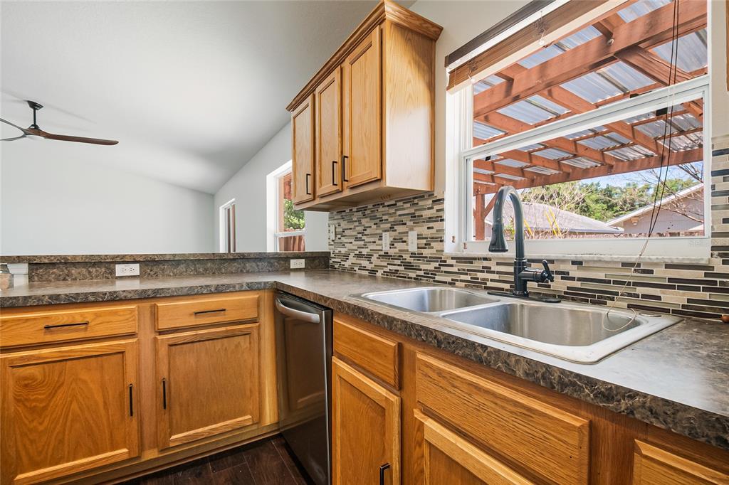 221 Rosa Avenue Oviedo, FL 32765 - Photo 12 of 36 a kitchen with stainless steel appliances granite countertop a sink and a stove