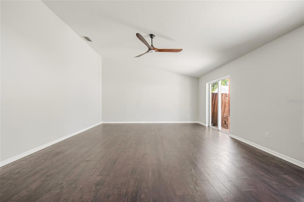 221 Rosa Avenue Oviedo, FL 32765 - Photo 13 of 36 an empty room with wooden floor and windows