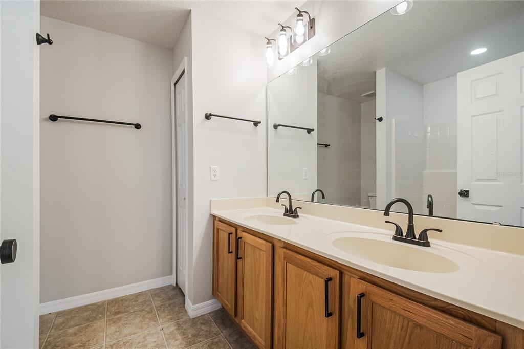 221 Rosa Avenue Oviedo, FL 32765 - Photo 30 of 36 a bathroom with a sink and mirror