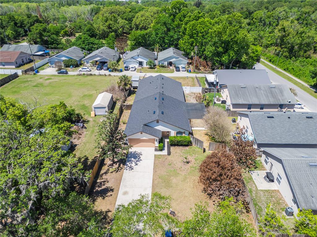 221 Rosa Avenue Oviedo, FL 32765 - Photo 4 of 36 an aerial view of a house with a garden and lake view